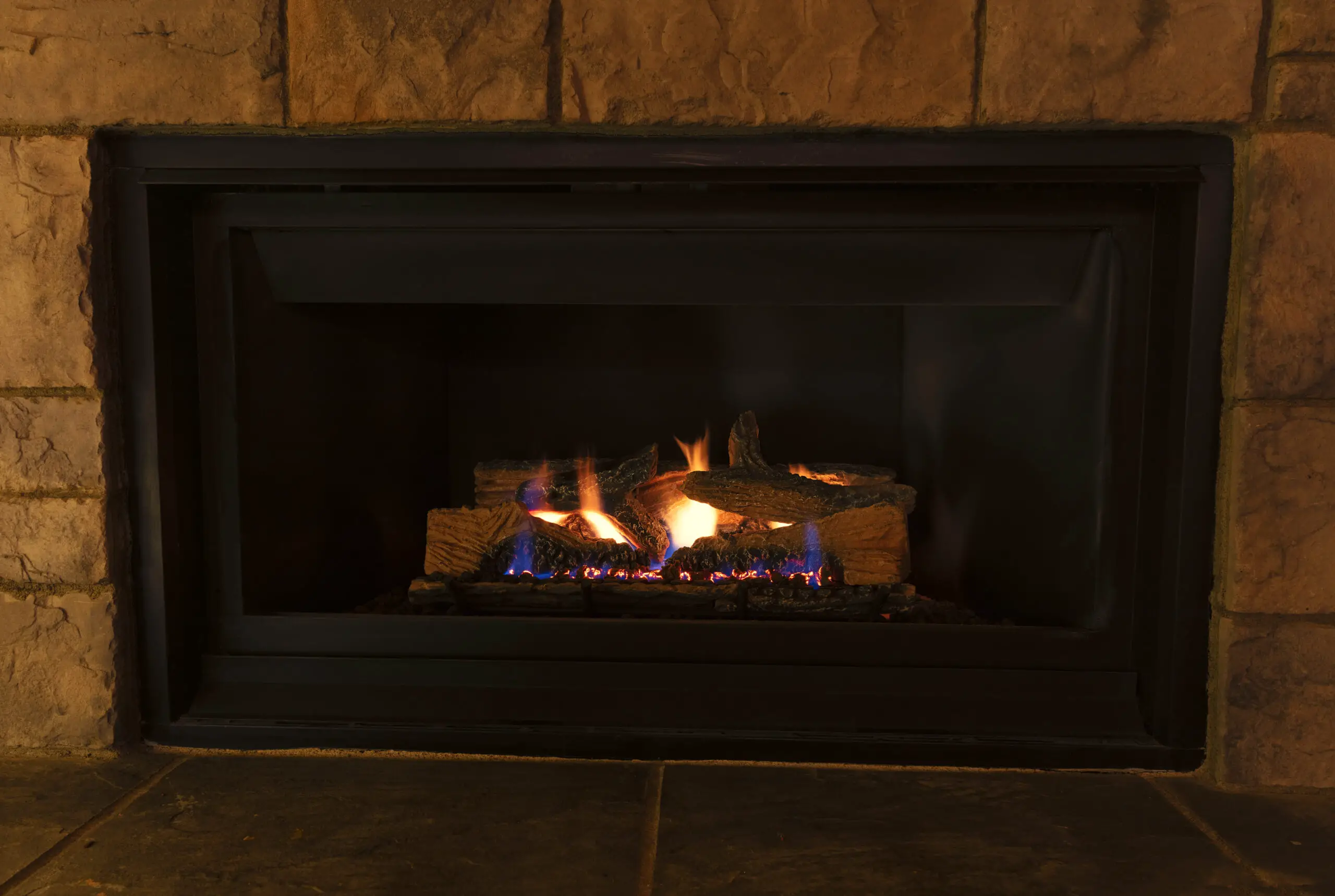 Burning natural gas fireplace during the evening at home